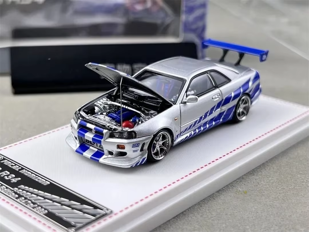 Silver and blue Focal Horizon Nissan Skyline GT-R R34 C-West die-cast model with hood open