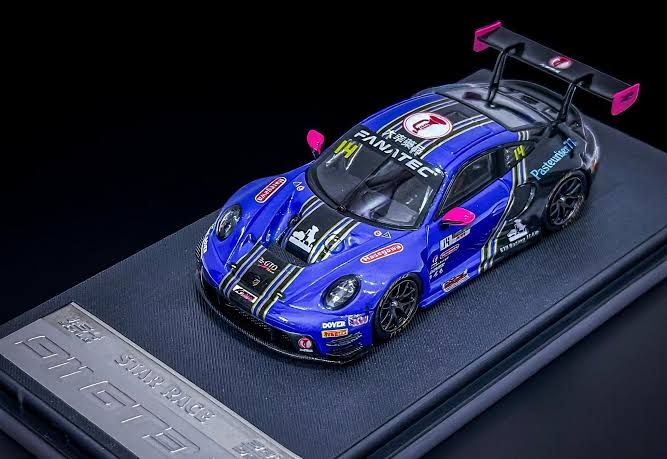 Blue-and-black Porsche 911 GT3 R No. 14 model with pink rear-wing accents on a black display base
