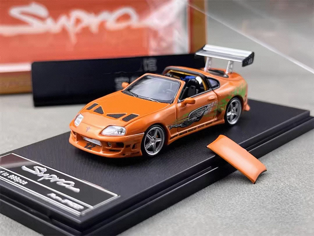 Orange A80 Targa-style miniature with modified body kit, silver alloy wheels, rear wing, and display base
