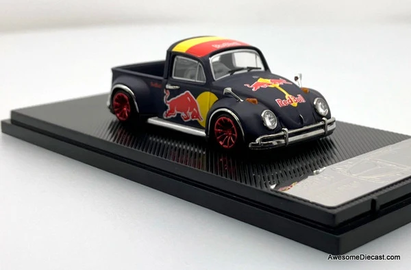 Black Volkswagen Beetle pick-up die-cast with Red Bull-themed graphics and red wheels on a display base